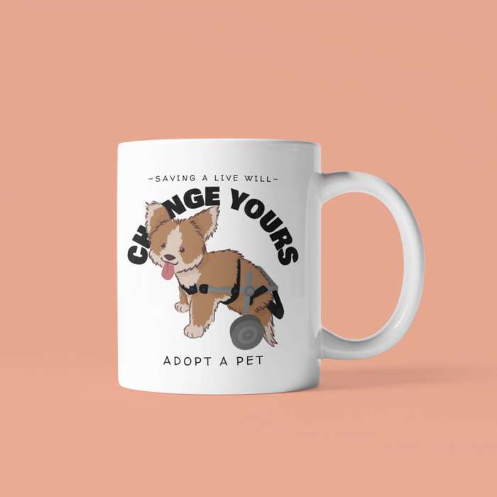 Adopt a Pet Mug: Transforming Lives, Making a Difference: white, brown cartoon dog with a rear wheel/wheelchair support