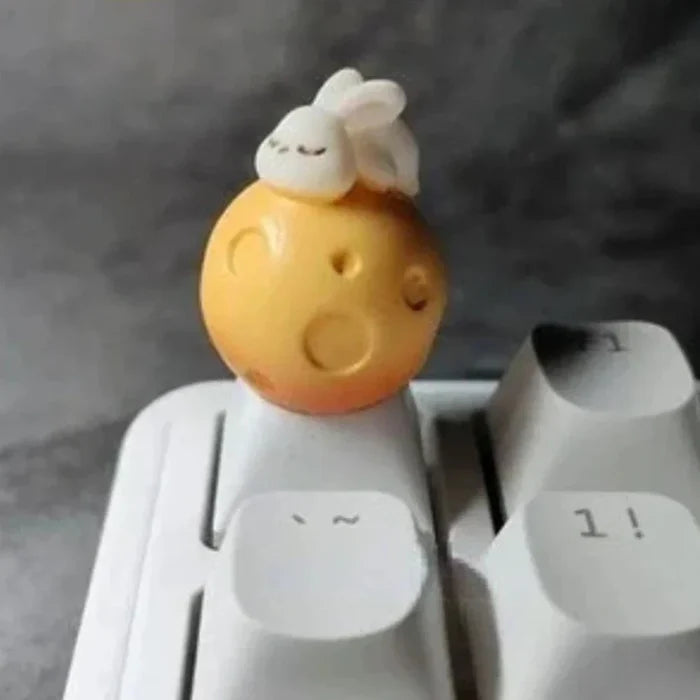 Cartoonish Pink Keycap Design: white, yellow-orange rabbit sitting on a moon, kawaii style
