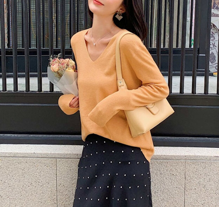 Casual Ladies V-Neck Pullover Sweater: coral orange long-sleeve V-neck sweater, minimal casual style