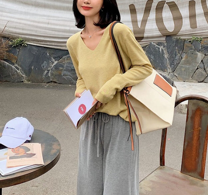 Casual Ladies V-Neck Pullover Sweater: coral orange long-sleeve V-neck sweater, minimal casual style