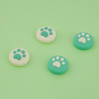 Cat Paw Switch Thumb Grips: turquoise, white animal paw print, minimal cartoon style