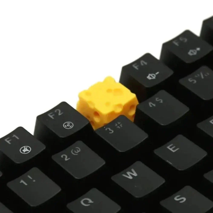 Cheese-Inspired ESC Keycap Design: black, yellow cheese, playful novelty style