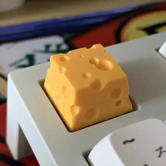 Cheese-Inspired ESC Keycap Design: black, yellow cheese, playful novelty style