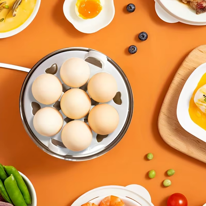 Compact Egg Cooker and Food Steamer: silver, white steaming basket with round buns, minimal food photography style