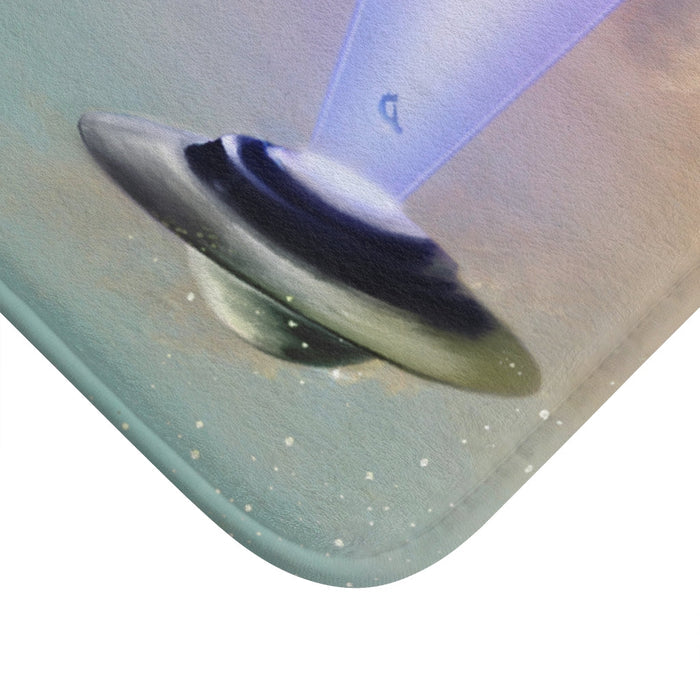 Cow Abducted by UFO Bath Mat, Home Decor Accessories: blue, purple UFO beaming light onto a rural field with people and cows