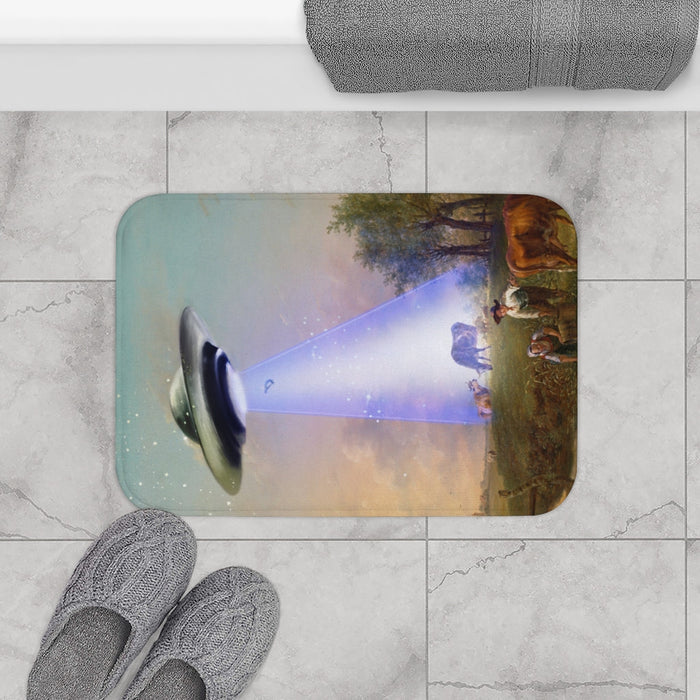 Cow Abducted by UFO Bath Mat, Home Decor Accessories: blue, purple UFO beaming light onto a rural field with people and cows