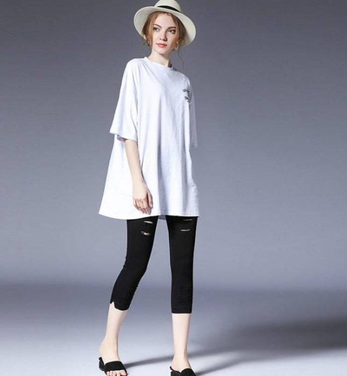 Crop Leggings with Distressed Design: black pants/leggings, minimal edgy style