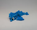 Blue dragon toy on a gray background