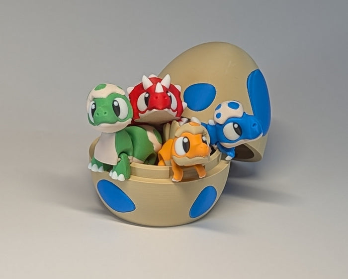 Cute Dino Creatures With Egg Red Blue Orange Green in the egg