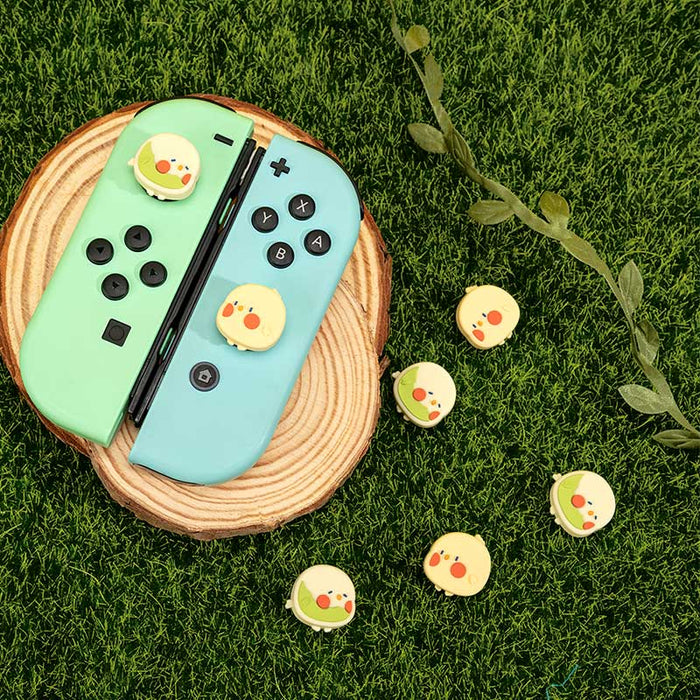 Cute gaming cat Switch joystick caps: mint green, light blue yellow chick character, kawaii cartoon style