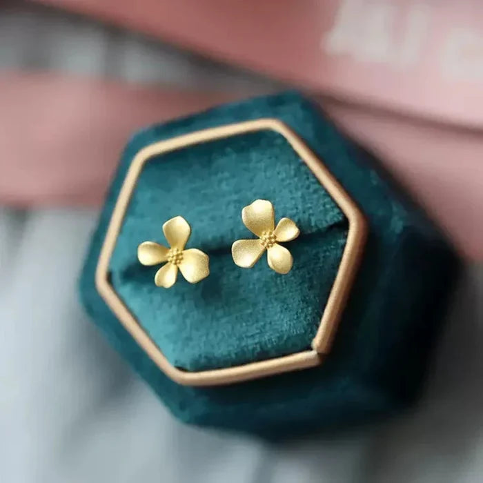 Floral Stud Earrings for a Subtle and Elegant Look: gold, pale pink background flower, minimal floral style