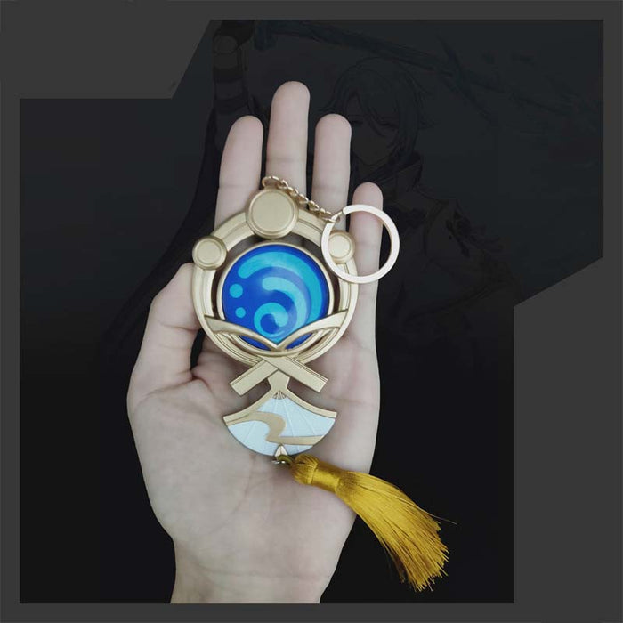 Genshin Impact Ayato Vision Keychain: gold, blue stylized water swirl emblem, ornamental cartoon-inspired style