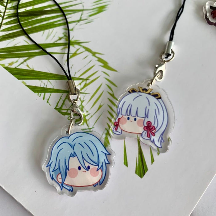 Genshin Impact Charms with Cute Designs: black, silver anime-style character faces and a circular star-themed emblem, kawaii