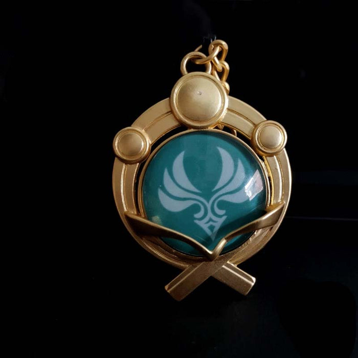 Genshin Impact Inazuma Vision Keychain: gold, teal stylized winged or floral emblem, ornamental fantasy-inspired style