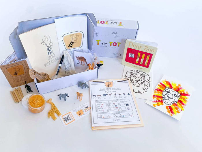 Play and learn zoo kit for kids with a giraffe playdough cutter, homemade playdough, zoo map, vet folder, and a 'Going to the Zoo' book. Includes a zoo sketch journal, play animals, scavenger hunt, and matching game with animal fur.