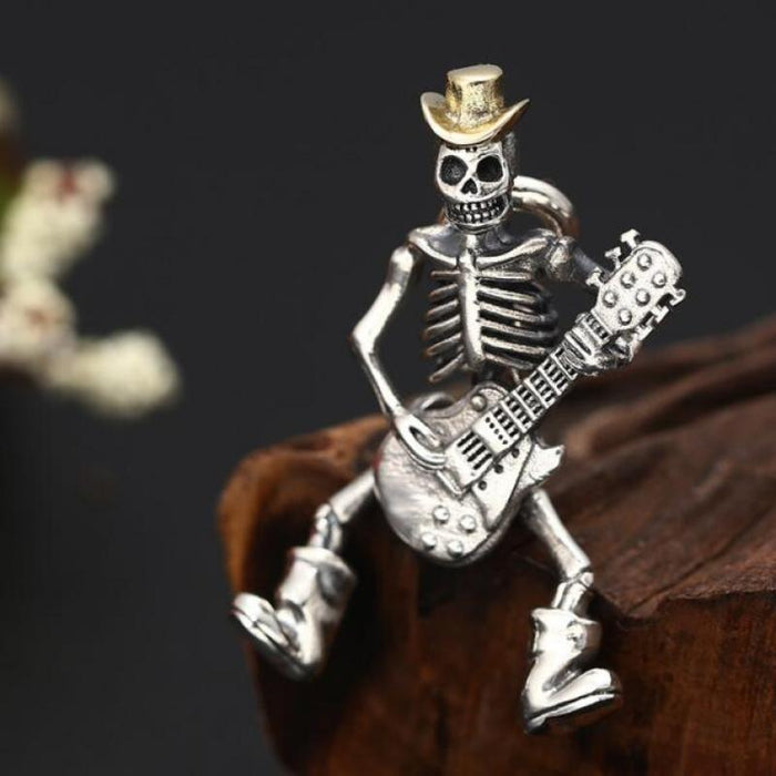 Guitar-Playing Skeleton Necklace: silver, gold skeleton musician with a guitar, cartoon gothic style