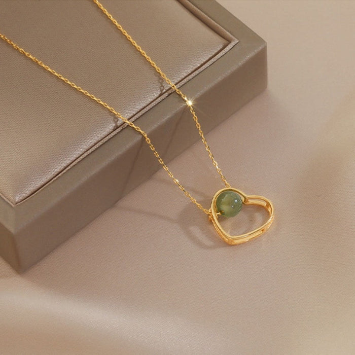 Heart of Gold: A Radiant Jade Necklace with a Touch of Elegance: gold, pale green pendant necklace, minimal style