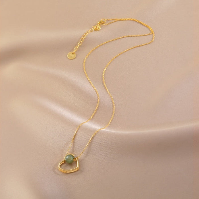 Heart of Gold: A Radiant Jade Necklace with a Touch of Elegance: gold, pale green pendant necklace, minimal style