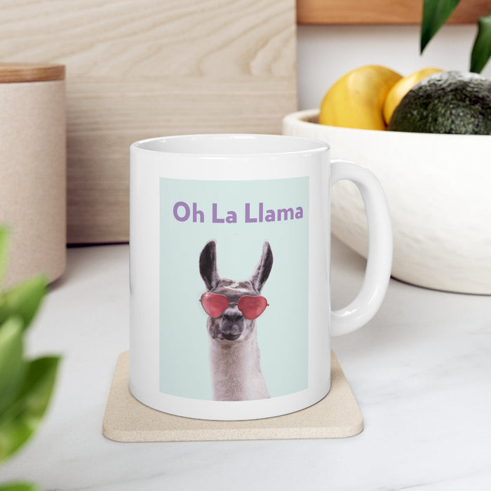 La Llama Oh Mug: white, light blue llama, cartoon-like novelty graphic style