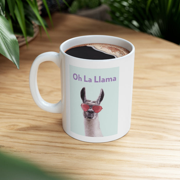La Llama Oh Mug: white, light blue llama, cartoon-like novelty graphic style