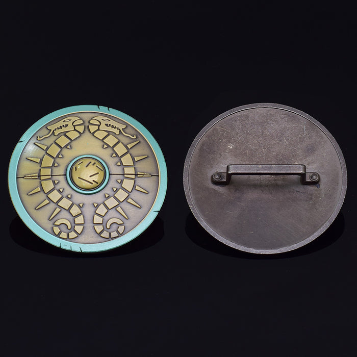 Legend of Zelda Traveler's Shield Metal Model: turquoise, gold centipede-like creature, stylized fantasy cartoon style