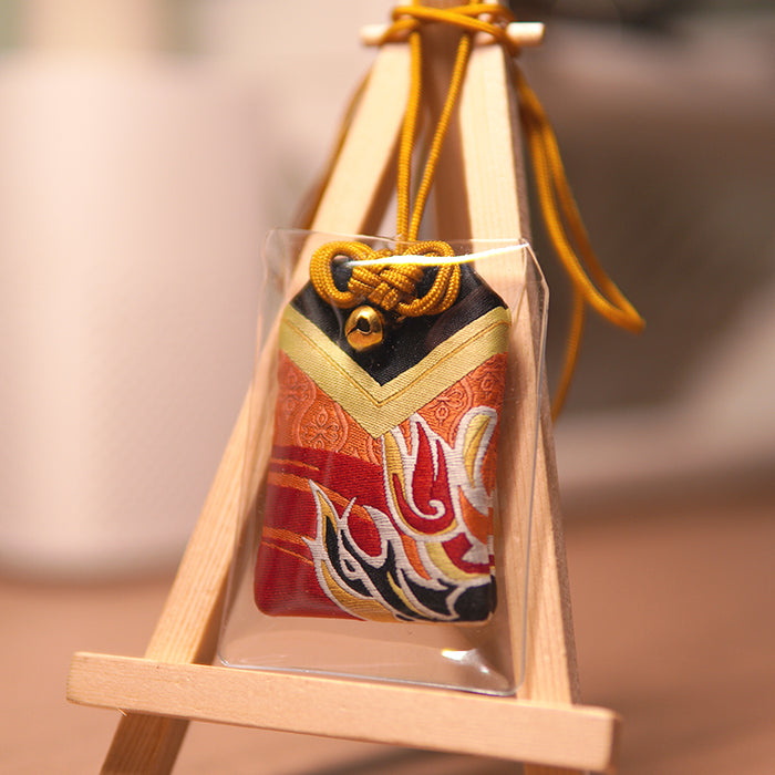 Lucky Omamori, Genshin Impact Quest Item: red, gold decorative drawstring pouch ornament on a small wooden easel, traditional