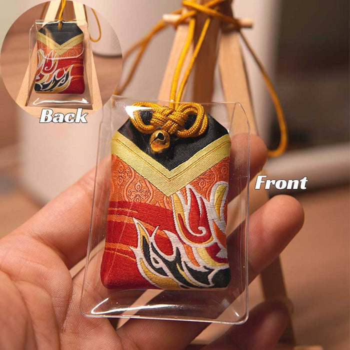 Lucky Omamori, Genshin Impact Quest Item: red, gold decorative drawstring pouch ornament on a small wooden easel, traditional
