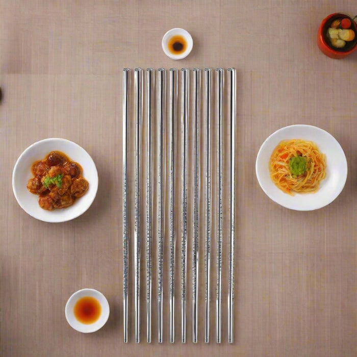 Set of 5 Pairs of Stainless Steel Chopsticks from Korea: golden brown, brown plate of stir-fried noodles, food photography st