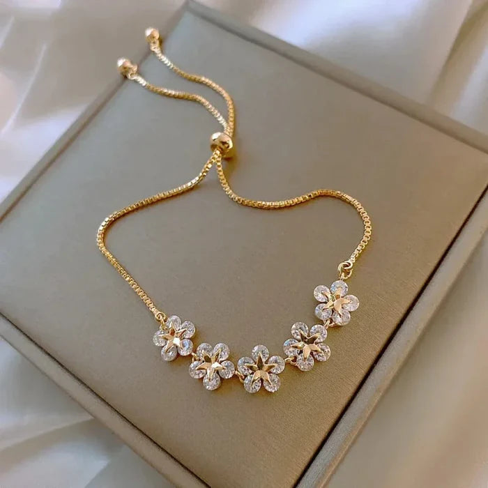 Shimmering Rhinestone Flower Bracelet with Floral Design: gold, clear/white flowers, delicate floral style