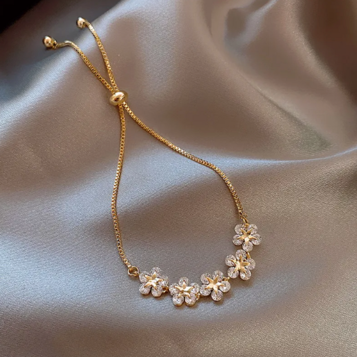 Shimmering Rhinestone Flower Bracelet with Floral Design: gold, clear/white flowers, delicate floral style