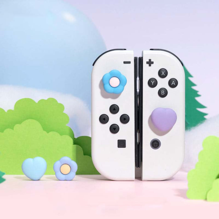 Silicone Switch Thumb Grips with Designs: pastel pink, pastel yellow soft cushion-like objects, minimal pastel style