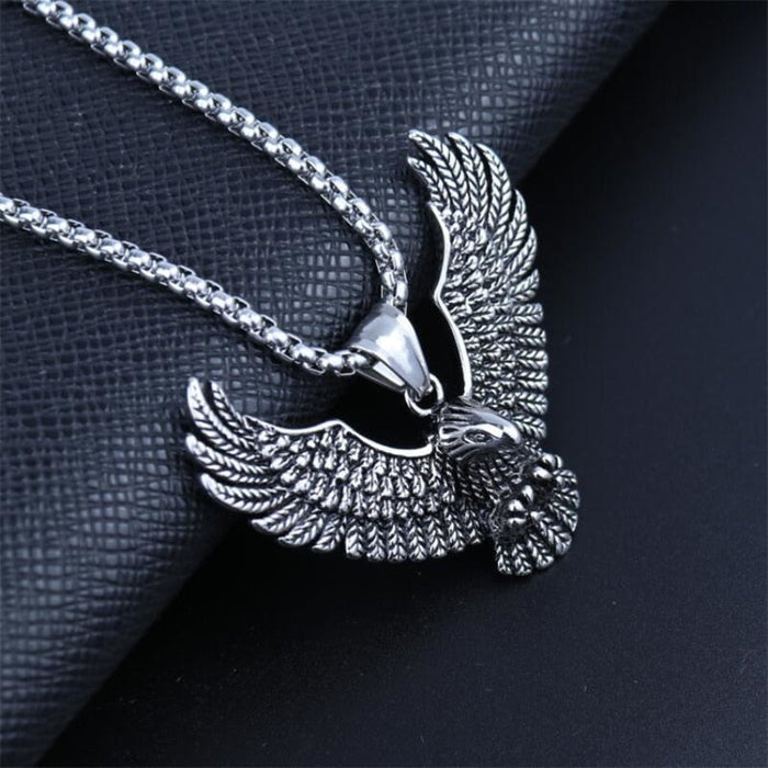 Soaring Falcon Pendant: silver, dark gray eagle, ornate realistic animal motif style