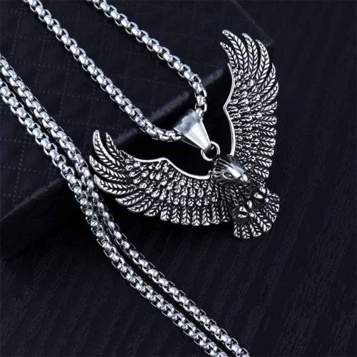 Soaring Falcon Pendant: silver, dark gray eagle, ornate realistic animal motif style