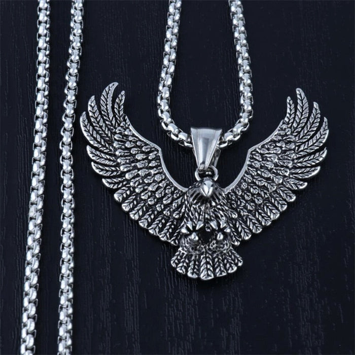 Soaring Falcon Pendant: silver, dark gray eagle, ornate realistic animal motif style