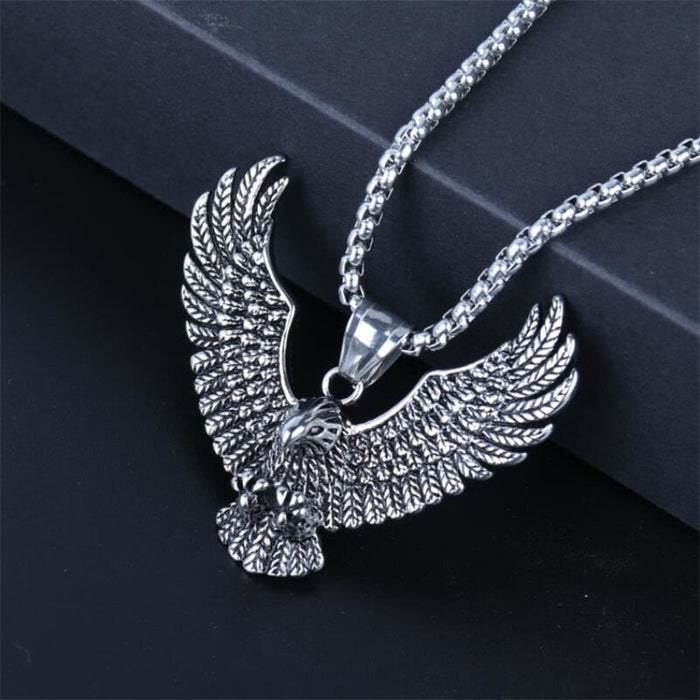 Soaring Falcon Pendant: silver, dark gray eagle, ornate realistic animal motif style