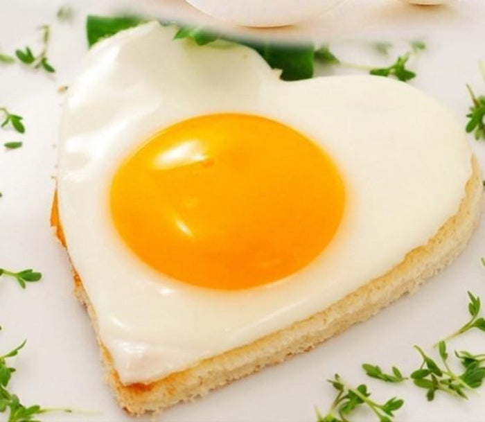 Stainless Steel Pancake Shaping Mold Set, 4 Pieces: white, yellow-orange fried egg on toast, food photography style