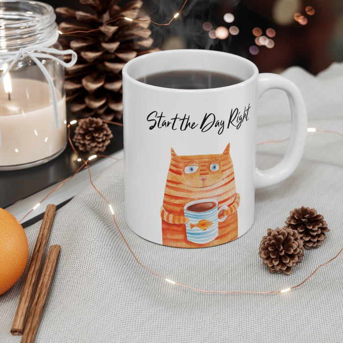 Start Your Day Off Right with the Cat Holding Goldfish Coffee Tea Mug: white, orange orange tabby cat holding a cup, cartoon