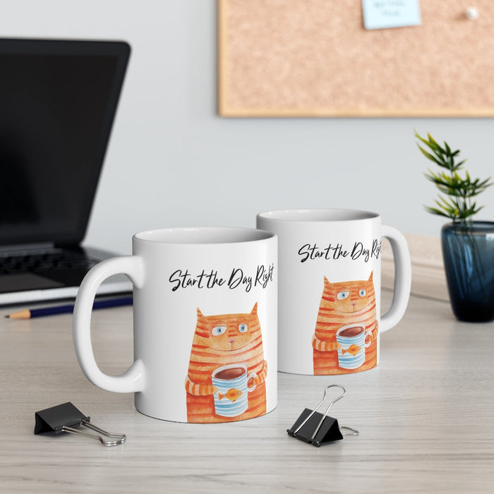 Start Your Day Off Right with the Cat Holding Goldfish Coffee Tea Mug: white, orange orange tabby cat holding a cup, cartoon