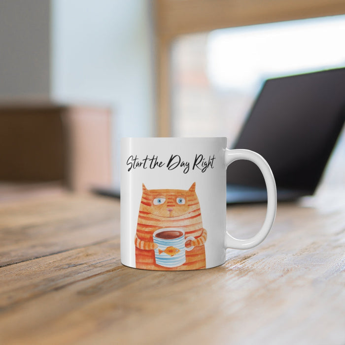 Start Your Day Off Right with the Cat Holding Goldfish Coffee Tea Mug: white, orange orange tabby cat holding a cup, cartoon