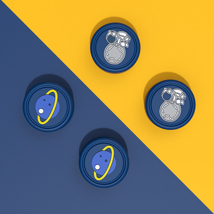 Switch OLED Thumb Grips with Designs: dark blue, yellow space theme (astronaut and ringed planet), cartoon style