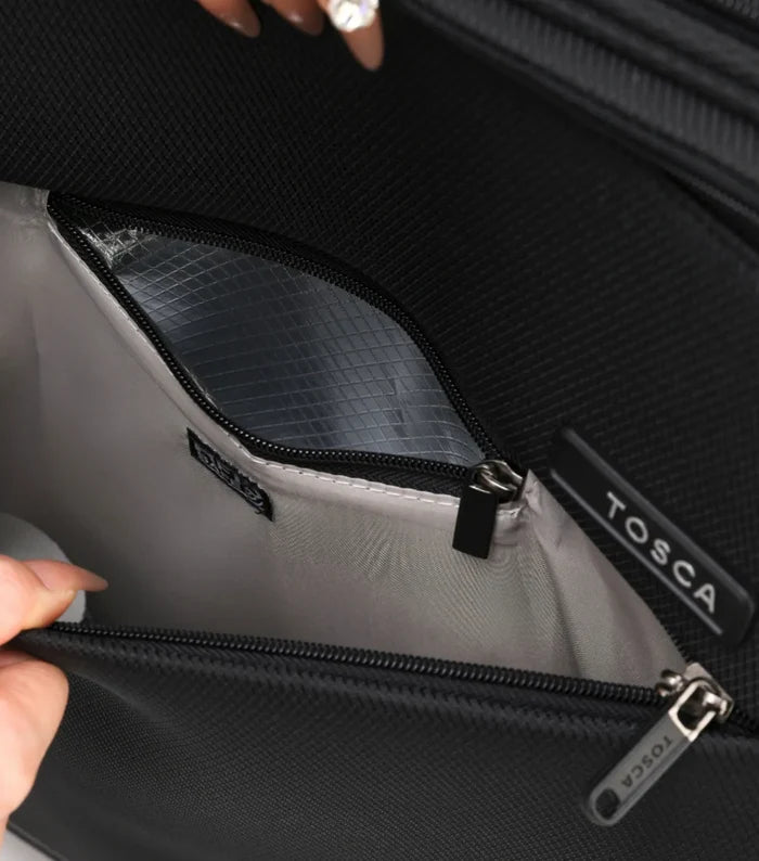 Black tosca branded trolley case interior with silver reflective lining and black zippers featuring deluxe jacquard material