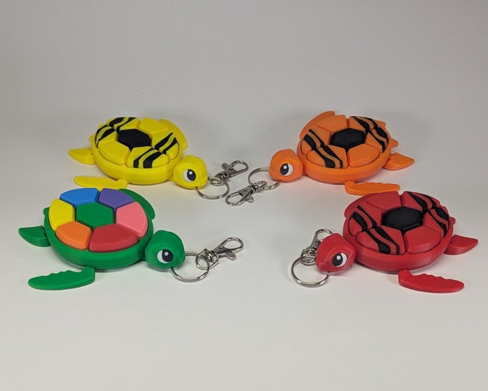 Sea Turtle Keychain Clickers Crayon and Rainbow laid out
